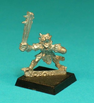 Pose 1, variant B. This figure is armed with a spiked wooden club. He is looking forwards, with 2 small horns and an open mouth showing short fangs and tongue.