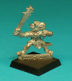 Pose 1, variant C. This figure is armed with a spiked wooden club. He is looking to the left, with 2 longish horns and a partly-open mouth showing bared teeth.