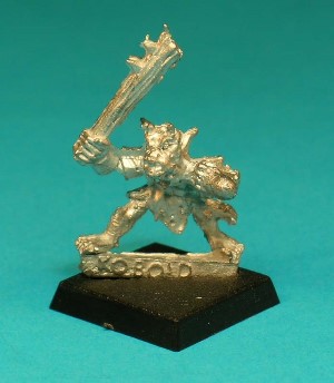 Pose 1, variant D. This figure is armed with a spiked wooden club. He is looking slightly to the left, with 2 small horns and a partly open, snarling and showing his teeth.