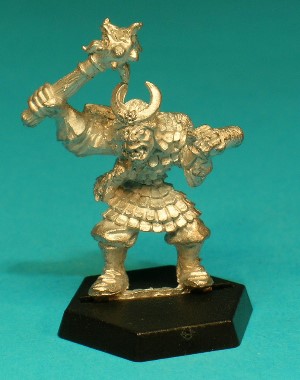 Pose 1, variant E. This variant wields a mace in the shape of a monstrous face covered with spikes. He wears a fur skullcap with a scalemail neckguard and a thin crescent-moon symbol on the front. His head looks forwards, with a part-open leering mouth, and he wears an eyepatch over his right eye.