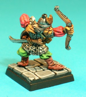 Pose 3, variant A. This pose is a Hobgoblin archer firing his shortbow. He is wearing armour made of a jerkin covered with small plates. He has a sword thrust through his belt, a small money pouch and a quiver of arrows over his back. This variant wears a conical, segmented helmet with a small crescent-shaped symbol on the front, and a studded steel neckguard. His head looks along the firing line of his arrow, with a slightly open, sneering mouth.