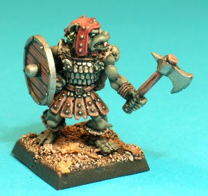 Pose 1, variant A. This Gnoll warrior wears a skirt made of studded leather strips and a scalemail tunic adorned with tatty furs. He carries a sheathed shortsword on his back and is armed with a hand axe in his left hand and a shield in his right. This variant wears a studded leather cap with long earflaps and his axe has a notched single blade and rear spike. He has a dog-like face with a short muzzle, and a part-open mouth revealing upper fangs and a small tongue. He looks to his left and has a fancy earring in each ear. Pose 1, variant A. This Gnoll warrior wears a skirt made of studded leather strips and a scalemail tunic adorned with tatty furs. He carries a sheathed shortsword on his back and is armed with a hand axe in his left hand and a shield in his right. This variant wears a studded leather cap with long earflaps and his axe has a notched single blade and rear spike. He has a dog-like face with a short muzzle, and a part-open mouth revealing upper fangs and a small tongue. He looks to his left and has a fancy earring in each ear.