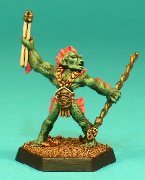 Pose 2, variant A. This Sahuagin seems to be a leader. He holds an ornate, twisted staff in his left hand and 3 short javelins in his right. He wears an ornate studded harness with a large buckle plate. This particular variant has a wide, squat head, with rounded, protruding ears and a 3-spined fin on the back of his head. He has small, oval eyes, his mouth is open in a shout, and his head is turned sharply to his left. Pose 2, variant A. This Sahuagin seems to be a leader. He holds an ornate, twisted staff in his left hand and 3 short javelins in his right. He wears an ornate studded harness with a large buckle plate. This particular variant has a wide, squat head, with rounded, protruding ears and a 3-spined fin on the back of his head. He has small, oval eyes, his mouth is open in a shout, and his head is turned sharply to his left.