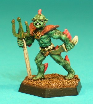 Pose 3, variant A. This Sahuagin is armed with a trident and a curved dagger. He wears a decorated belt and loancloth and a set of shoulder armour. This particular variant has a narrow, pointed face, with angular ears and a 4-spined fin on the back of his head. He has small, oval eyes, his mouth is partly open in a snarl, and his head is turned to his left. Pose 3, variant A. This Sahuagin is armed with a trident and a curved dagger. He wears a decorated belt and loancloth and a set of shoulder armour. This particular variant has a narrow, pointed face, with angular ears and a 4-spined fin on the back of his head. He has small, oval eyes, his mouth is partly open in a snarl, and his head is turned to his left.