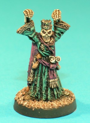 Pose 1, variant A. This is the Lich, an evil spellcaster in Undead form. He wears once-opulent robes and a cloak which are now badly tattered, and has a sceptre, a purse and a couple of rolled scrolls tucked into his sash. This particular variant has a completely skeletal head, and wears a jewelled crown. His mouth is closed and he looks directly forwards. Pose 1, variant A. This is the Lich, an evil spellcaster in Undead form. He wears once-opulent robes and a cloak which are now badly tattered, and has a sceptre, a purse and a couple of rolled scrolls tucked into his sash. This particular variant has a completely skeletal head, and wears a jewelled crown. His mouth is closed and he looks directly forwards.
