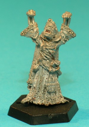 Pose 1, variant C. This Lich variant has a flesh-covered face with many wounds and holes in it, most noticeably on his left cheek and right temple. His left ear is intact, but his right is missing. He has short hair with a centre parting, and wears a jewelled circlet around his head. His mouth is open and he looks upwards and slightly to the right. This variant is easy to mistake for 1D. Pose 1, variant C. This Lich variant has a flesh-covered face with many wounds and holes in it, most noticeably on his left cheek and right temple. His left ear is intact, but his right is missing. He has short hair with a centre parting, and wears a jewelled circlet around his head. His mouth is open and he looks upwards and slightly to the right. This variant is easy to mistake for 1D.